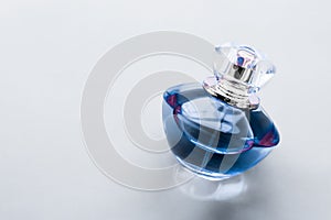 Blue perfume bottle on glossy background, sweet floral scent, glamour fragrance and eau de parfum as holiday gift and luxury