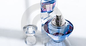 Blue perfume bottle on glossy background, sweet floral scent, glamour fragrance and eau de parfum as holiday gift and luxury