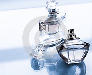 Blue perfume bottle on glossy background, sweet floral scent, glamour fragrance and eau de parfum as holiday gift and luxury