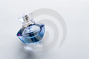 Blue perfume bottle on glossy background, sweet floral scent, glamour fragrance and eau de parfum as holiday gift and luxury