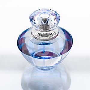 Blue perfume bottle on glossy background, sweet floral scent, glamour fragrance and eau de parfum as holiday gift and luxury