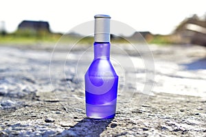 Blue perfume bottle isolated on a white background