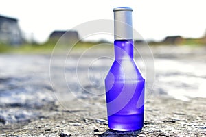 Blue perfume bottle isolated on a white background