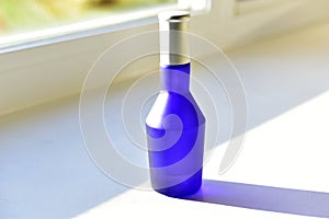 Blue perfume bottle isolated on a white background