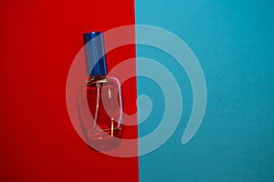 Blue perfume bottle on a red and blue background