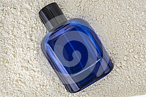blue perfume bottle on a white textured background