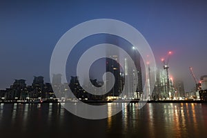 Blue photo dawn photo of london skyline in fog over St Georges Wharf at Vauxhall