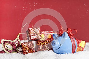 Blue pig with a red bow, mask, presents