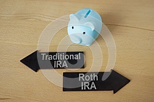 Blue piggy bank and arrows Traditional and Roth IRA.
