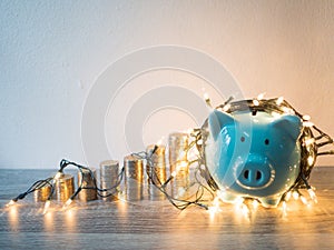 Blue piggy bank with .coins pile growth graph and Party lights, Funly saving money for future investment plan and retirement fund