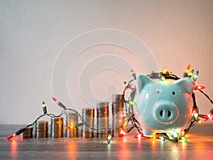 Blue piggy bank with .coins pile growth graph and Party lights, Funly saving money for future investment plan and retirement fund
