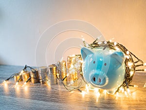 Blue piggy bank with .coins pile growth graph and Party lights, Funly saving money for future investment plan and retirement fund