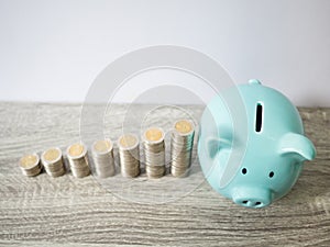 Blue piggy bank with coins pile growth graph, saving money for future investment plan and retirement fund concept