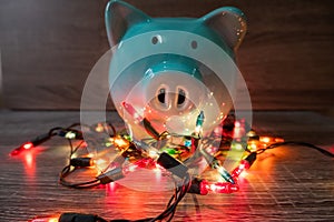 Blue piggy bank with party light, planning a party for the event where successful in saving money for use in various festivals