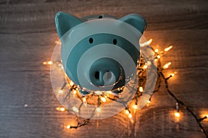 Blue piggy bank with party light, planning a party for the event where successful in saving money for use in various festivals