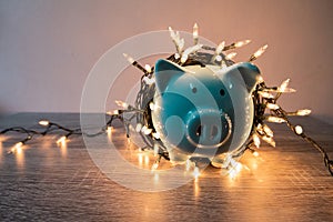 Blue piggy bank with party light, planning a party for the event where successful in saving money for use in various festivals