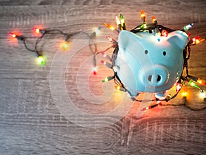 Blue piggy bank with Party lights, Enjoy savings for the holidays concept