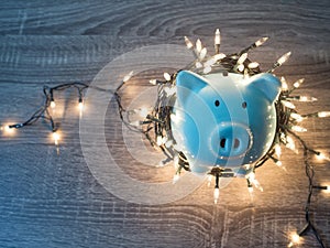 Blue piggy bank with Party lights, Enjoy savings for the holidays concept