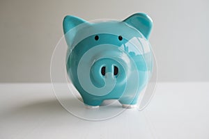 Blue piggy bank with white background, step up growing business to success and saving for retirement concept