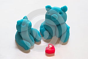 Blue piggy figure made from play dough and heart-shaped candles