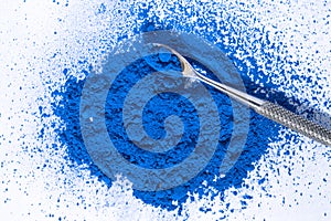 blue pigment, dry paint on a white background, macro