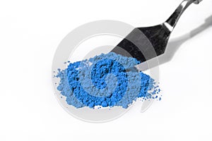 blue pigment, dry paint on a white background, macro