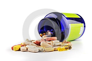 Blue pill bottle and assorted pills