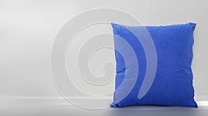 Blue pillow on against room background wall