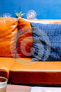 Blue pillow on leather sofa