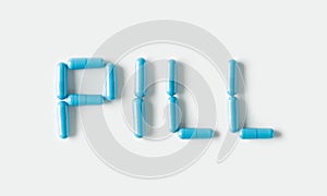 Blue Pills capsules in shape of word Pill. Life concept isolated.