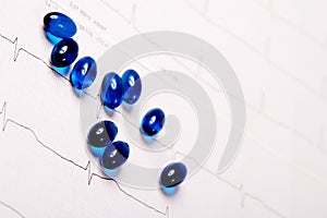 Blue pills on ECG chart (electrocardiogram)