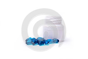 Blue pills and medicine bottle isolated on white background.