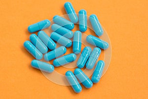 Blue pills on orange background