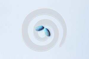 Blue pills on white background