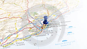 A blue pin stuck in Barcelona on a map of Spain