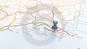 A blue pin stuck in Cartagena on a map of Spain photo