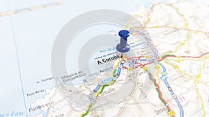A blue pin stuck in A Coruna on a map of Spain photo