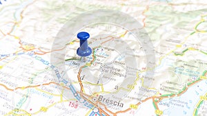 A blue pin stuck in Lake Iseo on a map of Italy photo