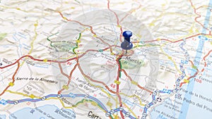 A blue pin stuck in Murcia on a map of Spain photo