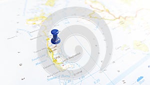 A blue pin stuck in South Uist Island on a map of Scotland photo