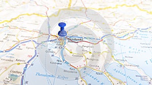 A blue pin stuck in Thessaloniki on a map of Greece photo