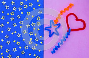 Blue and pink background. Red heart. Valentine`s day. Blue background with yellow stars. Crafts made of fluffy wire