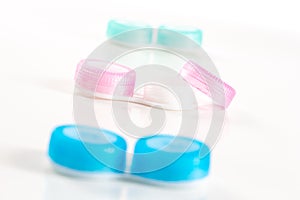 Blue and pink plastic contacts case on the white background