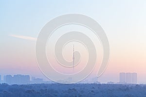 Blue pink sky over city and TV tower in sunrise