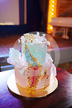 blue and pink two-tier cakes with gold decor for the girl's eighteenth birthday.