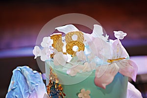 blue and pink two-tier cakes with gold decor for the girl's eighteenth birthday.