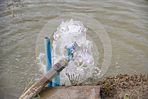 Blue pipe pump rush water falling in pond