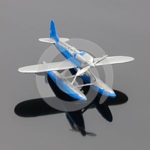 Blue plastic aquaplane on the grey mirror background