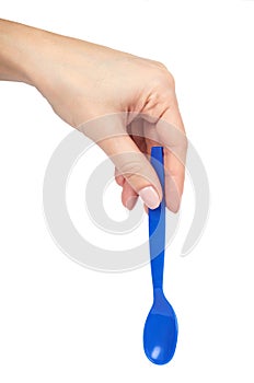 Blue plastic baby spoon with hand. Isolated on white background. Kids food utensil