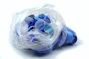 Blue plastic bottle caps sorted by colors in transparent single use plastic bags. PP an PET pollution.